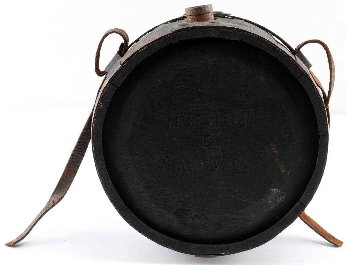 CIVIL WAR CONFEDERATE EARLY WOOD CANTEEN: Civil War Confederate canteen. Wood construction with copper rings. Marked "Wintfield EX Charlotte NC" on one side and "Returned July 14th 1863" on the other. Has original leather strap. Very good con