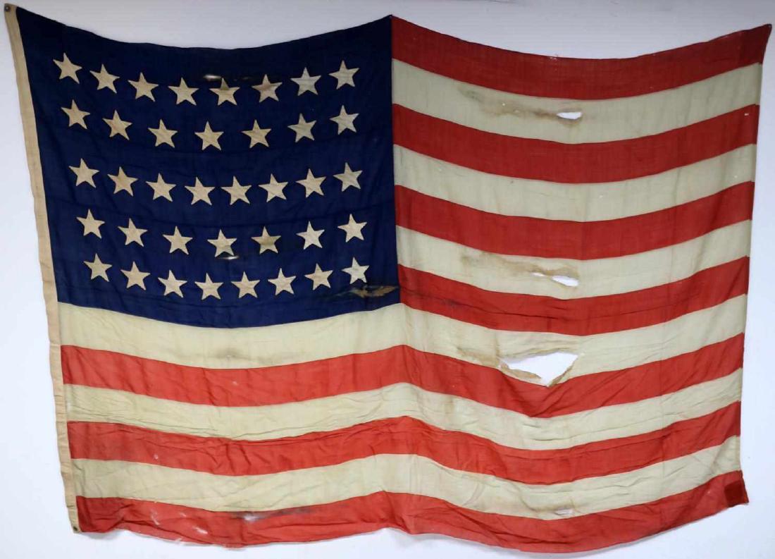 UNITED STATES AMERICAN FLAG WITH 38 STARS RED: Stars sewn to both sides. Rips and stains evident. Fair condition. Measures 127 X 89 inches. No maker's marks.