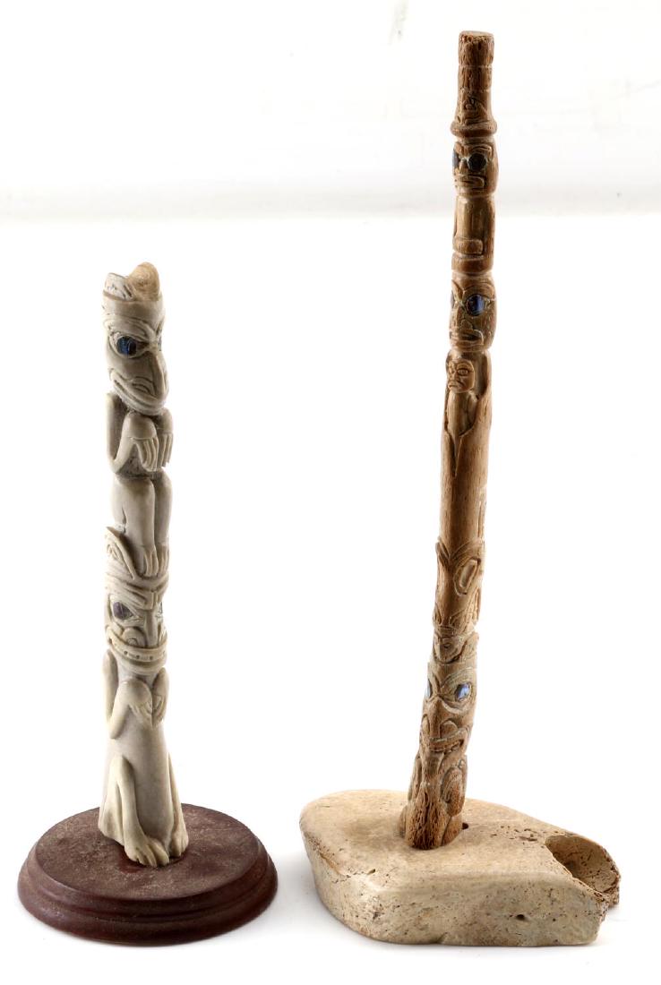 LOT TWO POLISHED BONE NATIVE AMERICAN TOTEM POLES: Lot of two small Native American hand carved totem poles. One fossil whale bone thin totem pole with bone base. Measures 10 inches in height. One polished bone totem pole with wood base. Measures 7.5 
