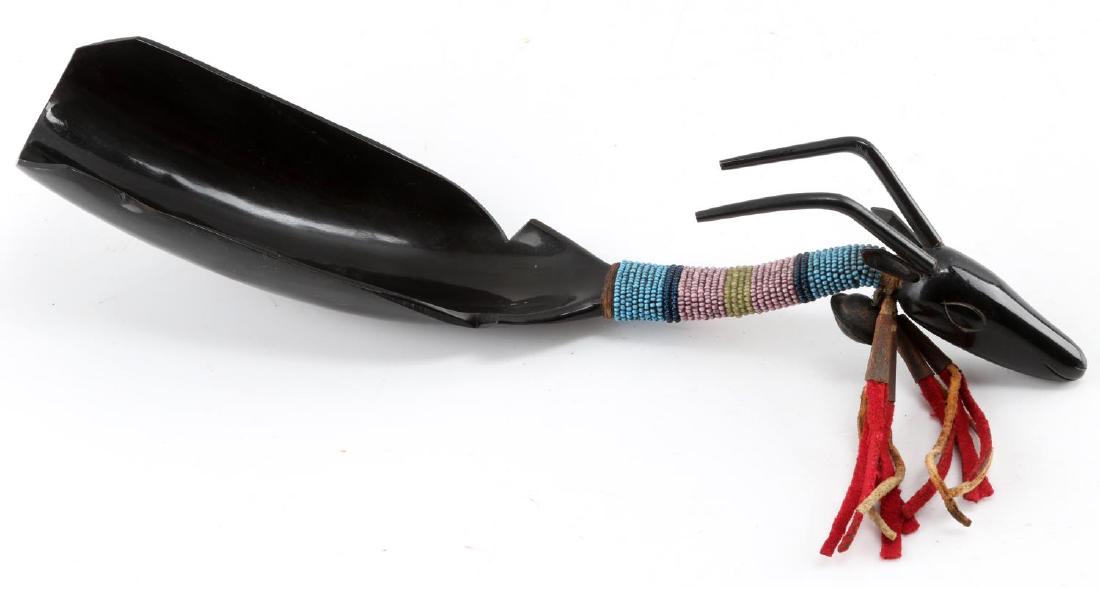 HAND CARVED UTE POLISHED ANTELOPE HORN SPOON: Hand Carved Ute Polished Antelope Horn Spoon with intricately carved antelope pommel and beaded handle with leather tassel. 12 inche in total length.