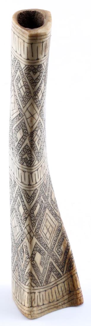 ANTIQUE CARVED ETCHED & MODIFIED ANIMAL TIBIA BONE: Antique carved & modified animal tibia bone which appears to be from a quadripedal mammal. Etching is done in intricate detail with 3 bordered sections, each filled with detailed engraving patterns. M