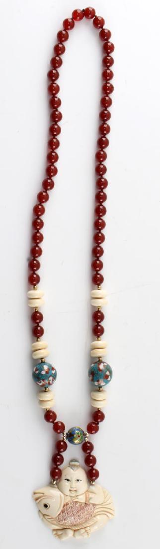 CARNELIAN & ENAMEL BEADED NECKLACE W ASIAN PENDANT: Necklace with carnelian, bone and enamel beads. Painted bone pendant of Asian figure holding over sized fish. Marked on back with Chinese figure for "fish." Measures 30 inches. In very good condition.
