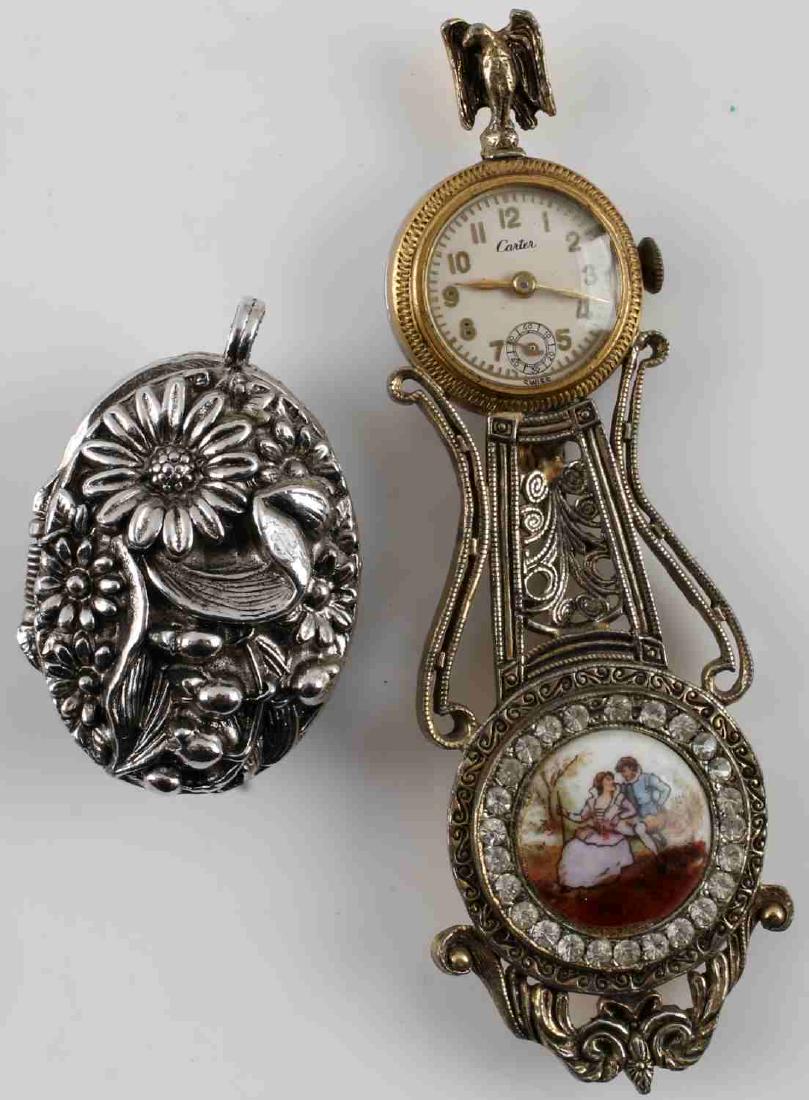 CARTER VINTAGE WATCH BROOCH & ENDURA PENDANT WATCH: Vintage Carter watch brooch. Eagle atop the watch face and painted Fragonard-like scene at bottom. Measures 3.5 inches. In working condition. Endura watch pendant. Case has floriated pattern and opens