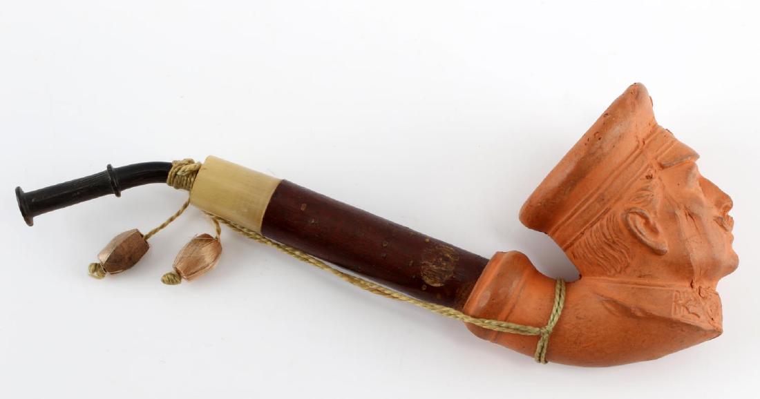 IMPERIAL GERMAN KAISER WILHELM PATRIOTIC PIPE: This is a clay and wood Kaiser Wilhelm pipe from Imperial era Germany. It measures 6" in length and is in good condition. 1 chip is present on the reverse where the clay and wood join. Otherwise, it i