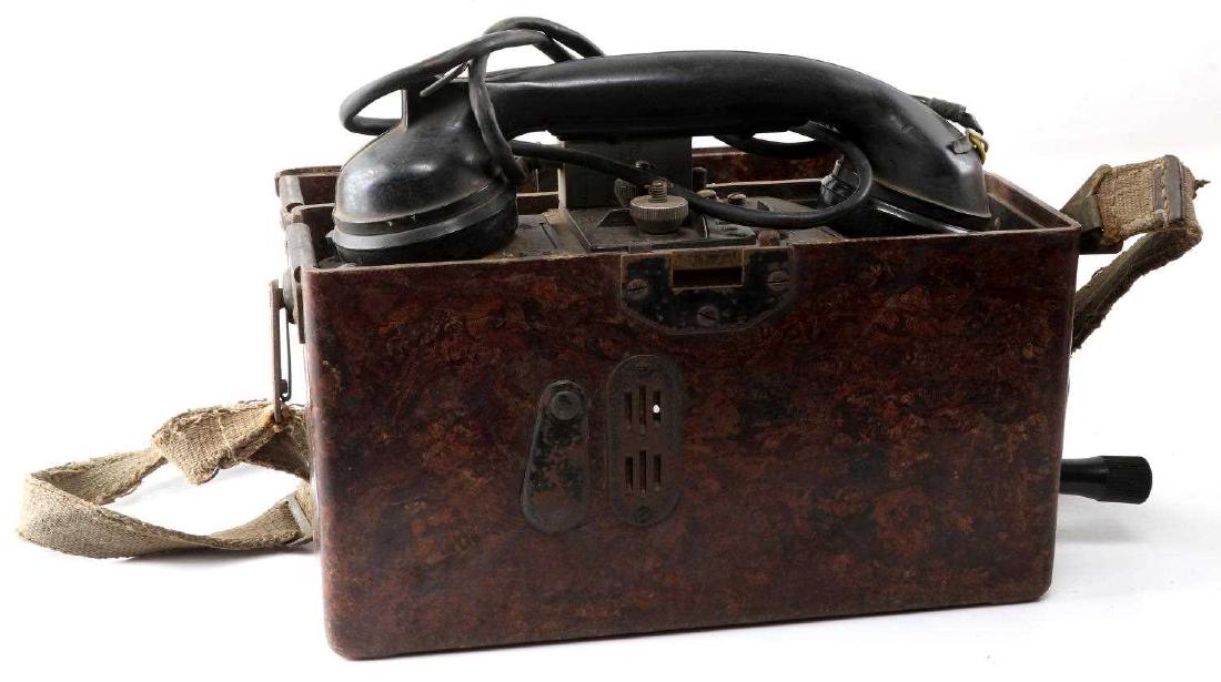 WWII GERMAN THIRD REICH WEHRMACHT FIELD PHONE: Large brown Bakelite carrier with hinged lid and spring loaded latch assembly, grease pencil grid, alpha chart riveted to lid, contains heavy Bakelite receiver, well marked inside. No damage to case. 