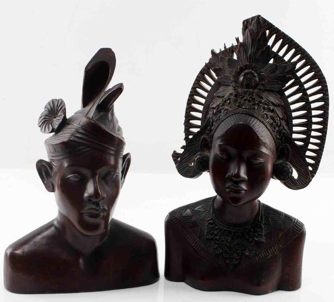 PAIR OF VETERAN BRING BACK CARVED INDONESIAN BUSTS: Pair of 20th century Veteran Bring back Dark-Brown carved wooden busts of an Indonesian or Polynesian couple in traditional garb, each complete with head dress and other trappings. Both measure 6 inch