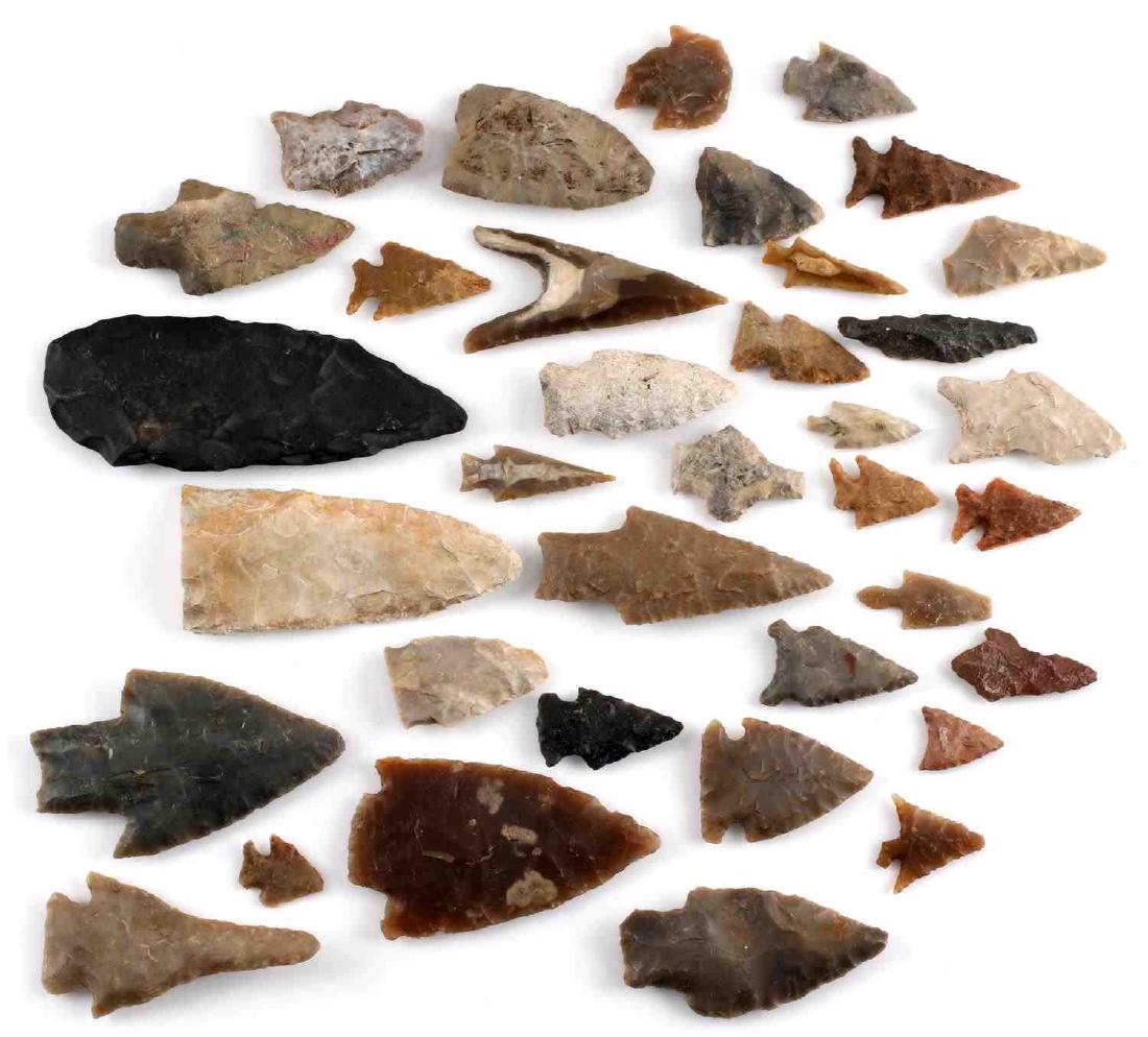 ARCHAIC NATIVE AMERICAN ARROWHEAD LOT OF OVER 30: Surface found Archaic Native American arrowheads from Central US. Lot features a great variety. A few repairs and broken sections present. Otherwise good overall. Unauthenticated; sold as is.