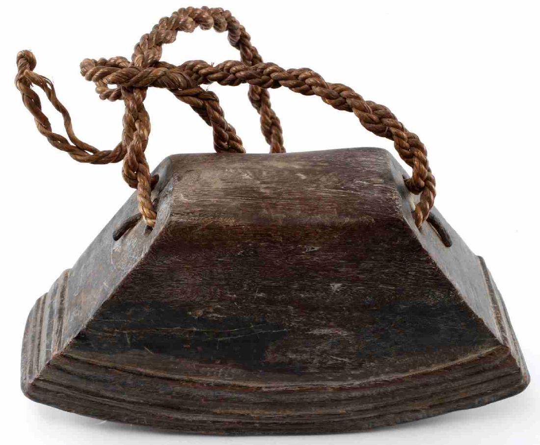 ANTIQUE PRIMITIVE WOODEN COW BELL WITH ROPE: Carved wooden bell with three clappers and rope for hanging. Measures 10 X 3 X 5.5 inches. Very good condition for age.