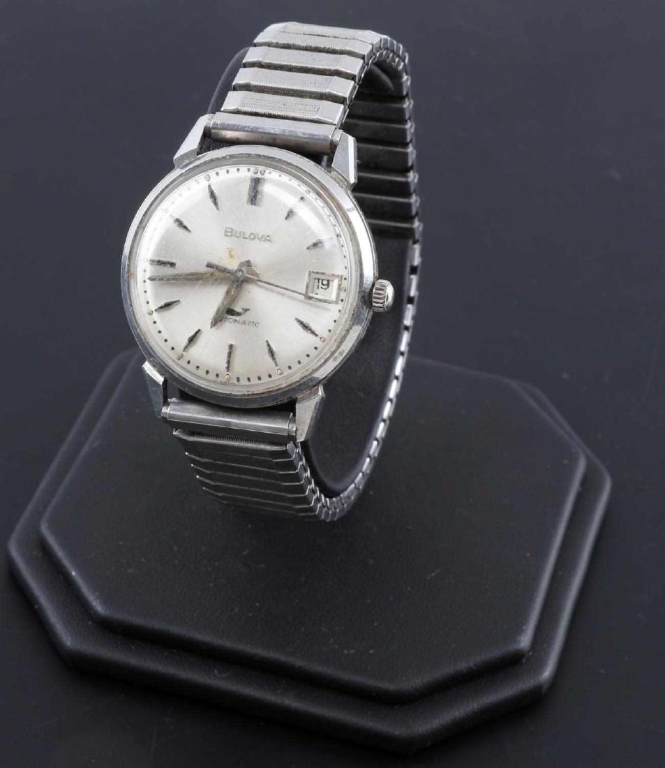 VINTAGE BULOVA AUTOMATIC WATCH WITH DATE DISPLAY: Features black bars as the numerals, date display on the right, maker marked and 'Automatic' to face. Speidel USA expandable band measures 64mm across when not stretched. Back is marked with '000096 N