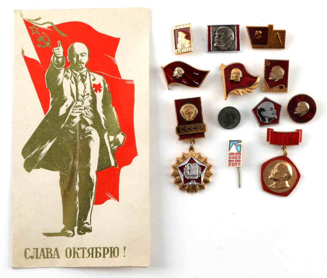 USSR SOVIET UNION LENIN BADGE AND PIN LOT: Large lot of Soviet badges and pins, most of which bear the profile of Vladimir Lenin. 12 in total. Also includes a 7 3/8 x 4 7/8 inch card with Lenin before the Soviet flag and a Soviet slogan beneat
