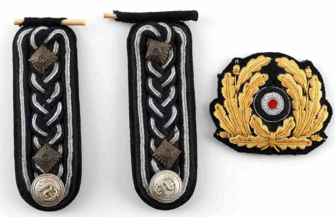 WWII GERMAN NAVY SHOULDER BOARDS CAP INSIGNIA: Blue and silver shoulder boards with Navy button to bottom, Kriegsmarine peak cap badge cloth. Both in very good condition.