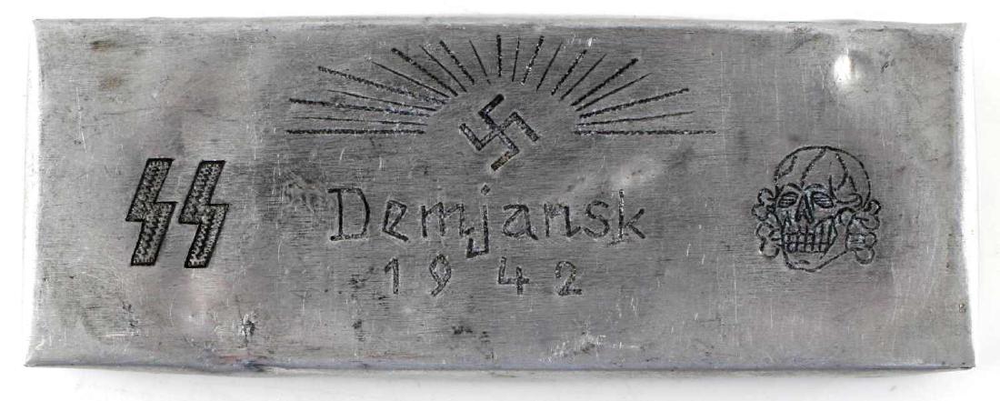 WWII GERMAN SS DIVISION TOTENKOPF DEMYANSK BOX: German SS Division Totenkopf battle of Demyansk trench art trinket box. Has engraved sun rays over a swastika at its top and the double S Sig runes, "Demyansk 1942," and a totenkopf skull below. Sheet