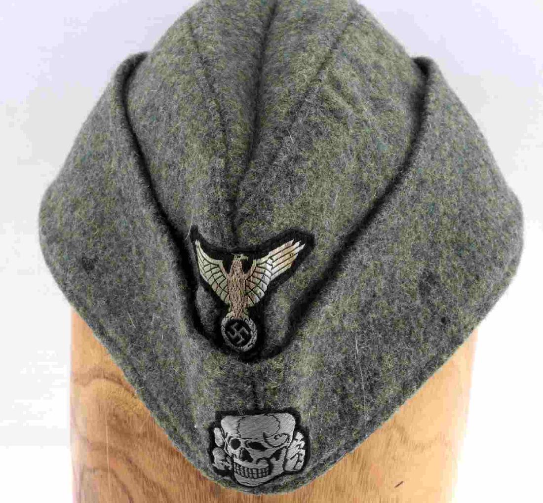 WWII GERMAN THIRD REICH WAFFEN SS EM OVERSEAS CAP: German SS Overseas cap. OD green wool body with SS bevo embroidered eagle and totenkopf skull machine stitched to front. Grey cotton interior lining marked "Clemens Wagner 1941 Braunsweig." Also stamp