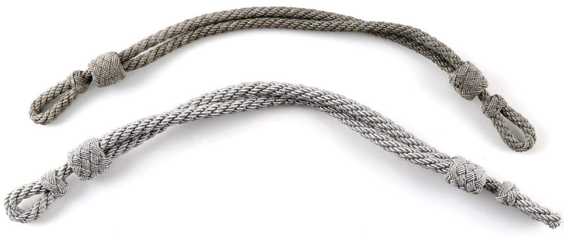 WWII GERMAN WEHRMACHT OFFICER VISOR CAP CHIN CORD: This lot includes 2 German officer visor cap chin cords. Silver and grey bullion wire construction. Very good original condition.