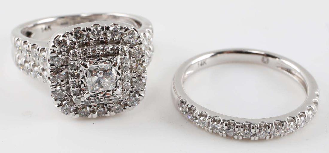14KT WHITE GOLD DIAMOND WEDDING RING SET .895 TCW: Features a 3.5 mm princess cut diamond to center with VS2 clarity and I-J color, twenty .8 mm round diamonds framing the centerpiece, sixteen 1.5 mm round diamonds to outer frame and eight 1.5 mm roun