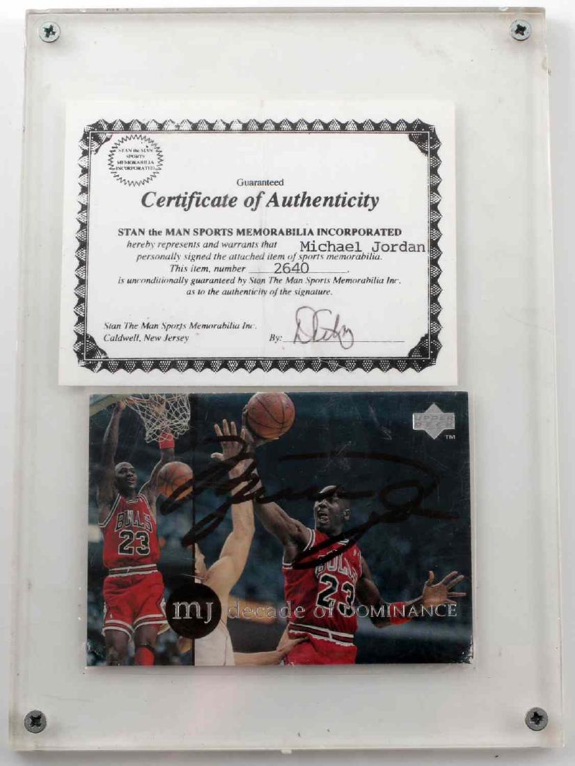 MICHAEL JORDAN SIGNED RAREAIR CARD AUTHENTICATED: Michael Jordan signed Upper Deck card. Encased in a plastic case with a Certificate of Authenticity from Stan the Man Sports Memorabilia Inc.. Some damage to both lower corners, otherwise very good to