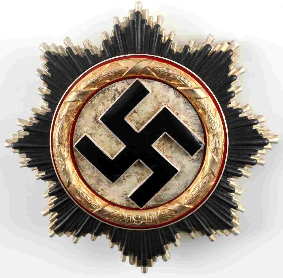 WWII THIRD REICH GERMAN CROSS AWARD IN GOLD: German Cross in Gold. No maker marks on the back of the badge. In very good condition, minor tarnish inside the golden ring. This lot has a reserve.