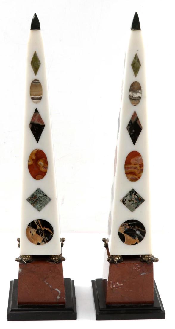 PAIR OF MARBLE SPECIMEN NEO CLASSICAL OBELISKS: Pair of neo-classical style marble specimen obelisks. Orange marble base white marble topper that is removable. Sits on four metal turtles attached to top of orange base. White marble has alternating