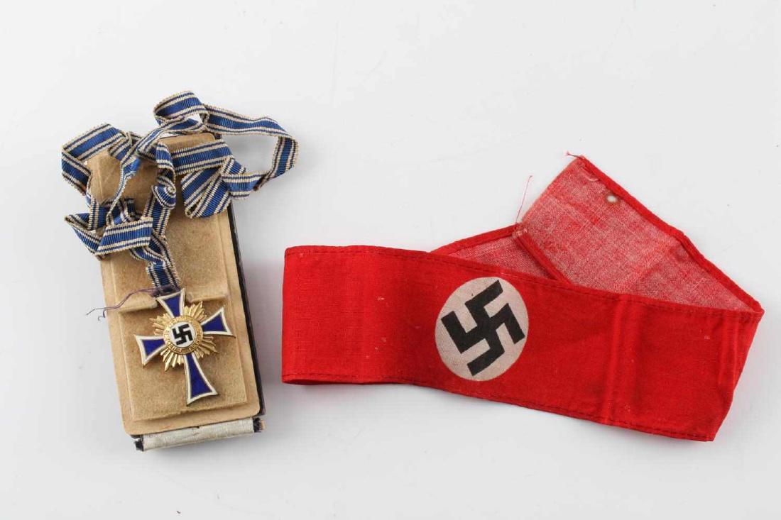 WWII GERMAN MOTHERS CROSS & ARMBAND LOT: This lot includes 1 cased German Mother's Cross by Richard Sieper & Sohne Ledenscheid and 1 small NSDAP armband. Mother's Cross is engraved with facsimile Adolf Hitler signature and the date 16 Decemb