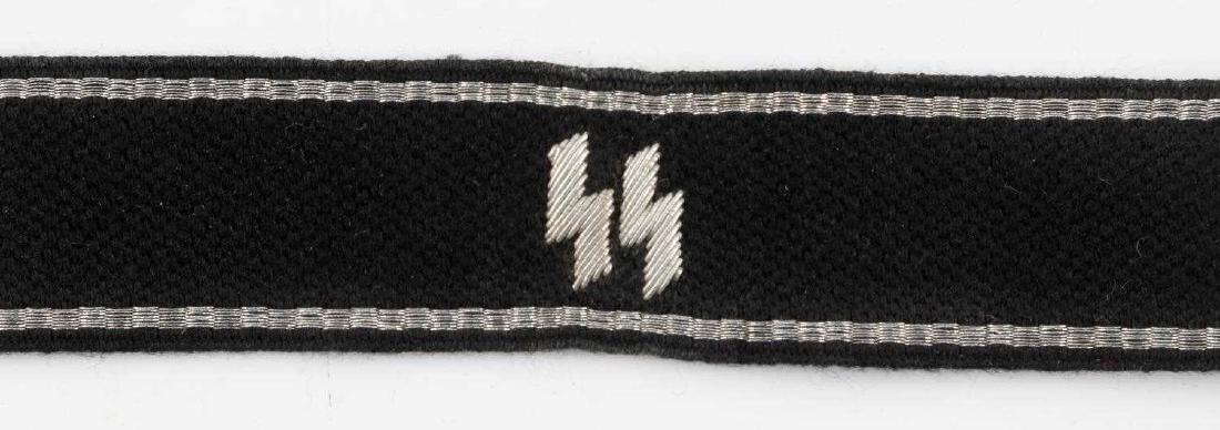 WWII GERMAN SS BRIGADE EHRHARDT CUFF TITLE: German SS Brigade Ehrhardt cuff title. Silver bullion wire piping with embroidered double S sig runes on front. Very good condition with only some slight fading and very small stains present. This lot