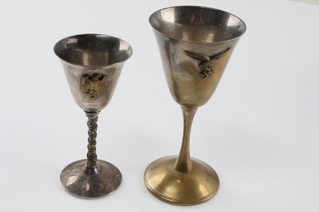 LOT OF 2 SMALL CORDIAL WINE GLASSES BRASS PLATE: One brass glass with Reichsadler to front, 5 5/8 inches tall, plus one silver plate Falstaff cordial glass, made in Spain, 4.75 inches tall. Very good condition.