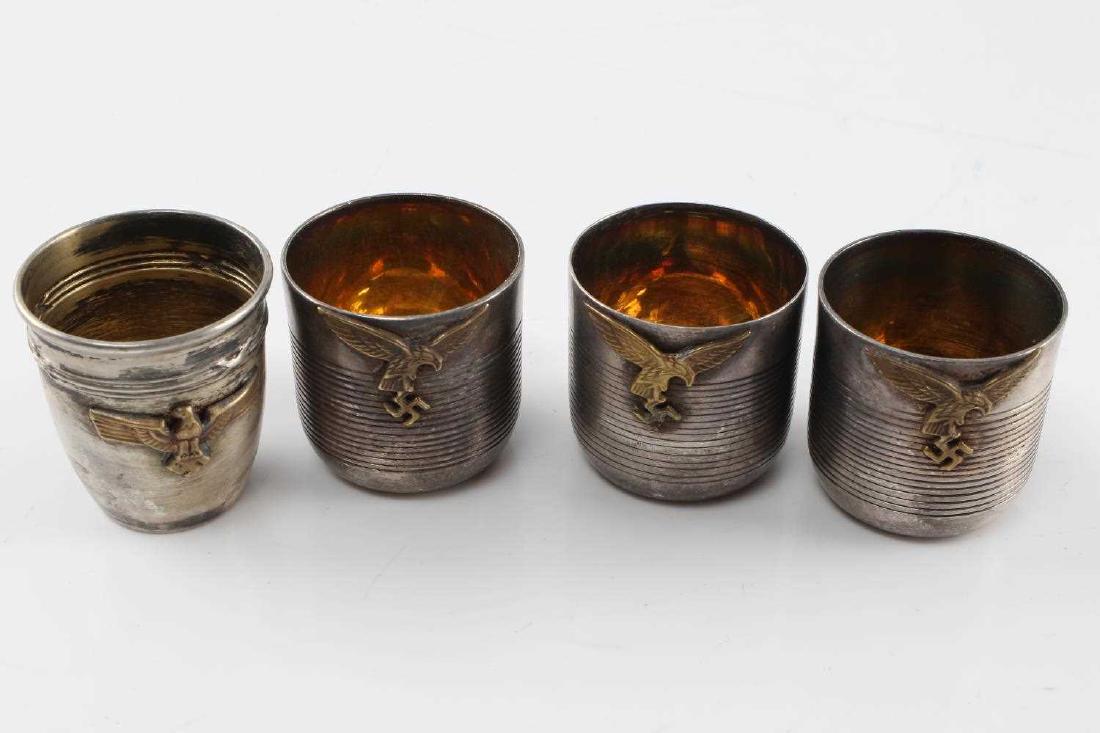 WWII THIRD REICH GERMAN SILVER PLATE SCHNAPPS CUPS: Three with brass colored Luftwaffe eagle and ribbed texture. Measure 1.5 inches tall. One with brass colored reichsadler and marked "Metand Blanc" at bottom. Measures 1.75 inches. All in good conditio