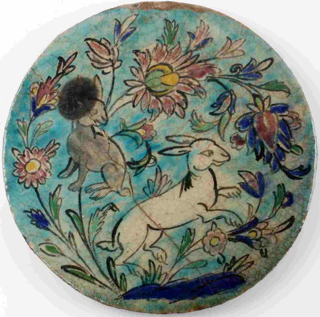 19TH C GLAZED & FIRED PERSIAN ZOOMORPHIC TILE: 19th century glazed and fired Persian decorative tile. Shows two rabbits with flowers. Measures 9.5 inches. Repaired crack across middle. Dark spot over small area and some chipping along edges.