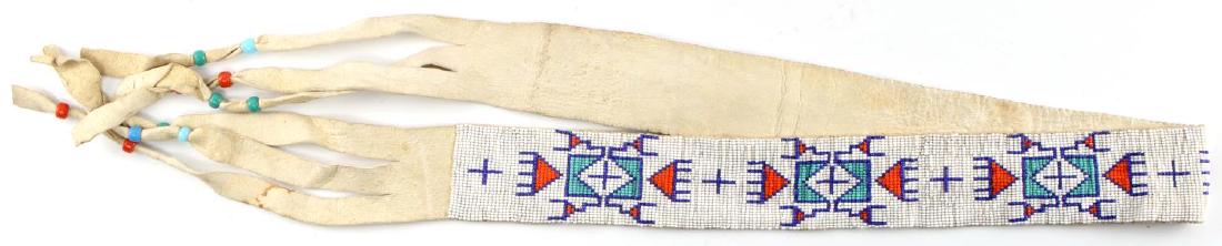 NATIVE AMERICAN BEADWORK & LEATHER BELT INDIAN: Beaded leather belt with predominately white beads. Has design with blue, aqua and orange beads. Ending leather strips are accented with same blue, aqua and orange beads. Measures 52 inches. In very g
