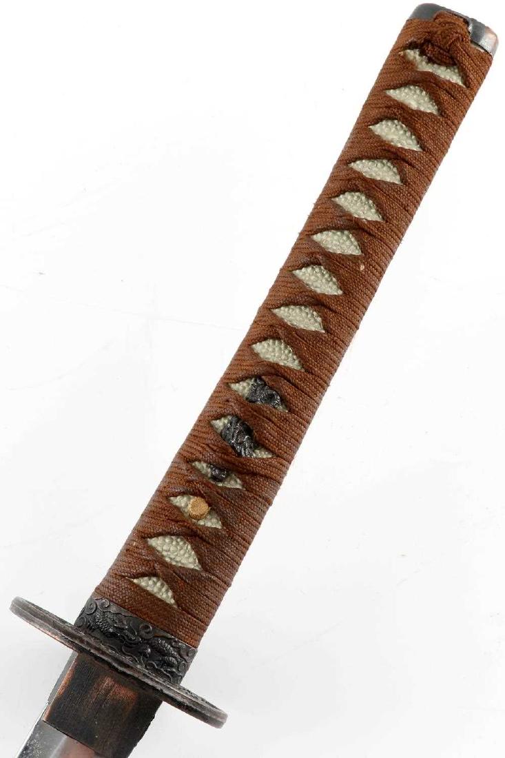 VINTAGE SAMURAI STYLE JAPANESE KATANA W SCABBARD: Modern manufactured Japanese katana in the Samurai style complete with scabbard, tsuba, locket and ribbon. Measures 41 inches in total length in scabbard.