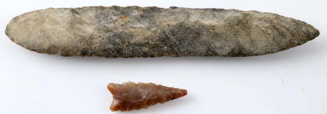 ARCHAIC RIVER FOUND LITHIC KNIFE BLADE & ARROWHEAD: Archaic period river-found lithic knife blade & arrow point, arrow point measures 1.5 inches in length, the lithic knife measures 6.5 inches long. In good condition with no signs of damage beyond expe