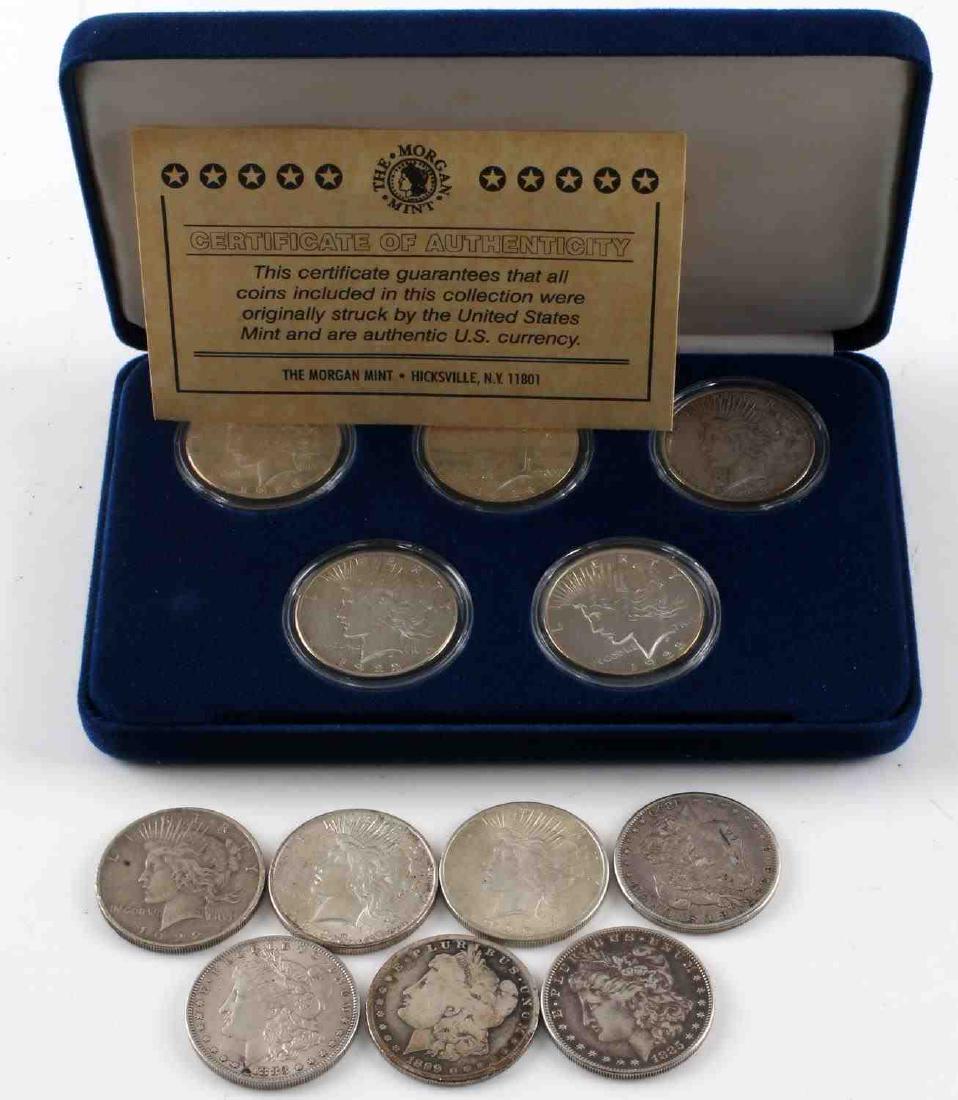 MORGAN AND PEACE SILVER DOLLAR COIN LOT OF 12: Lot contains 4 Morgan Silver Dollars and 8 Peace Dollars. Five of the Peace Dollars in a case from The Morgan Mint with a CoA from that organization. Includes 1883-O, 1885, two 1899, 1899-O, two 1922s