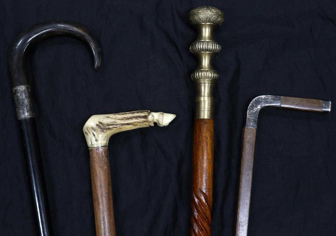 LOT OF 4 VINTAGE WALKING STICKS CANES BONE SILVER: 1 cane with bone handle with etched horse hoof design and 2 with engraved silver on handle or collar. Bone handle cane has silver ferrule tip. Good condition overall. Measure 35-38 inches long.