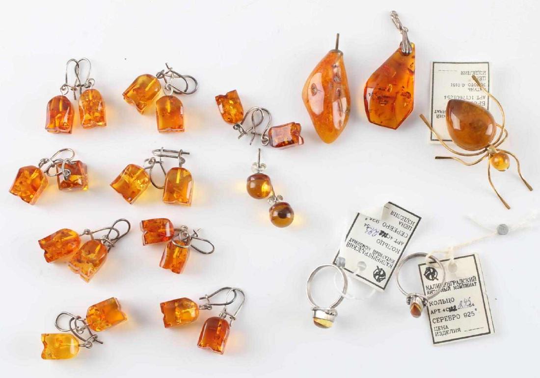 SOVIET AMBER PENDANT & EARRING LOT OF 15 PIECES: Lot contains 15 pieces of amber of Soviet origins. Includes 9 pairs of earrings, two rings, two pendants, and an ant brooch. A couple of pieces, including one of the pendants, appears to have a few in