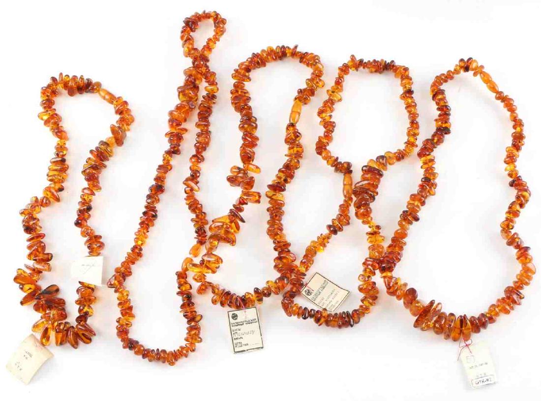 SOVIET AUTHENTICATED AMBER BEAD NECKLACE LOT: Lot of five amber bead necklaces. Each necklace has a paper label from a Soviet government-run factory guaranteeing the authenticity of the amber. Each necklace is about 10 inches long clasped. In ver