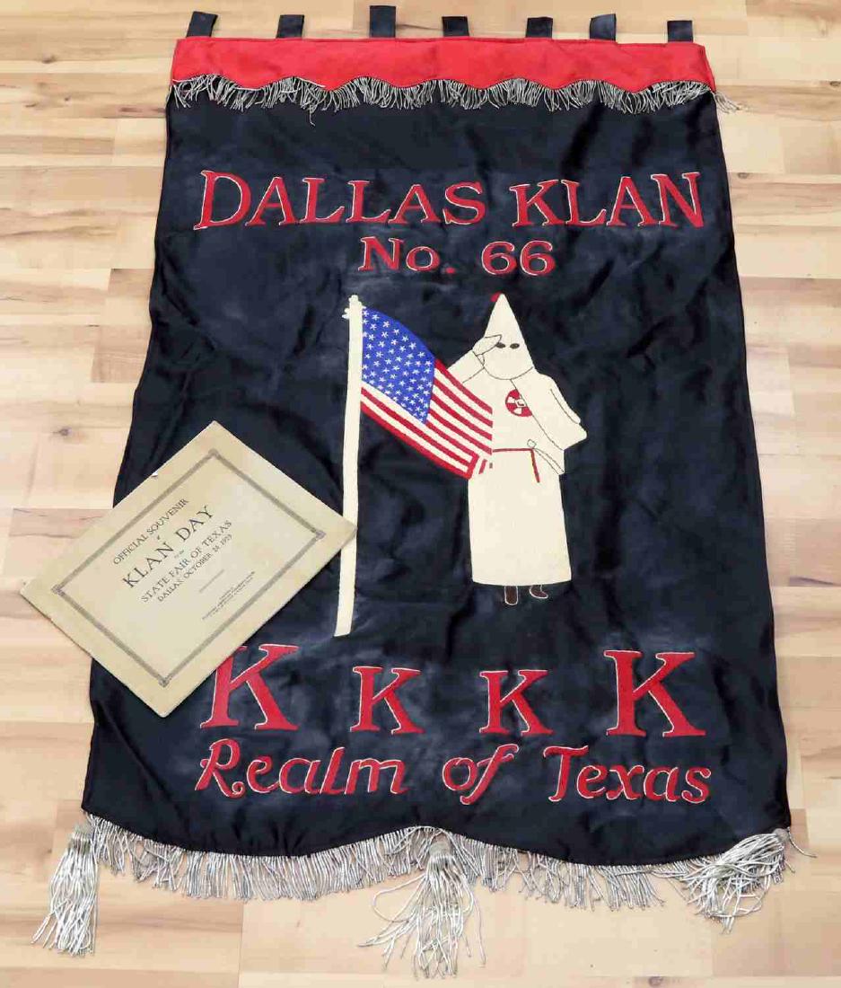 1920'S KKK BANNER REALM OF TEXAS DALLAS KLAN 66: Large 50 by 32 inches single sided fringe on top and bottom, robed figure holding flag is accompanied with 1923 Texas State fair in Dallas day booklet with parade photos. This lot has a reserve.
