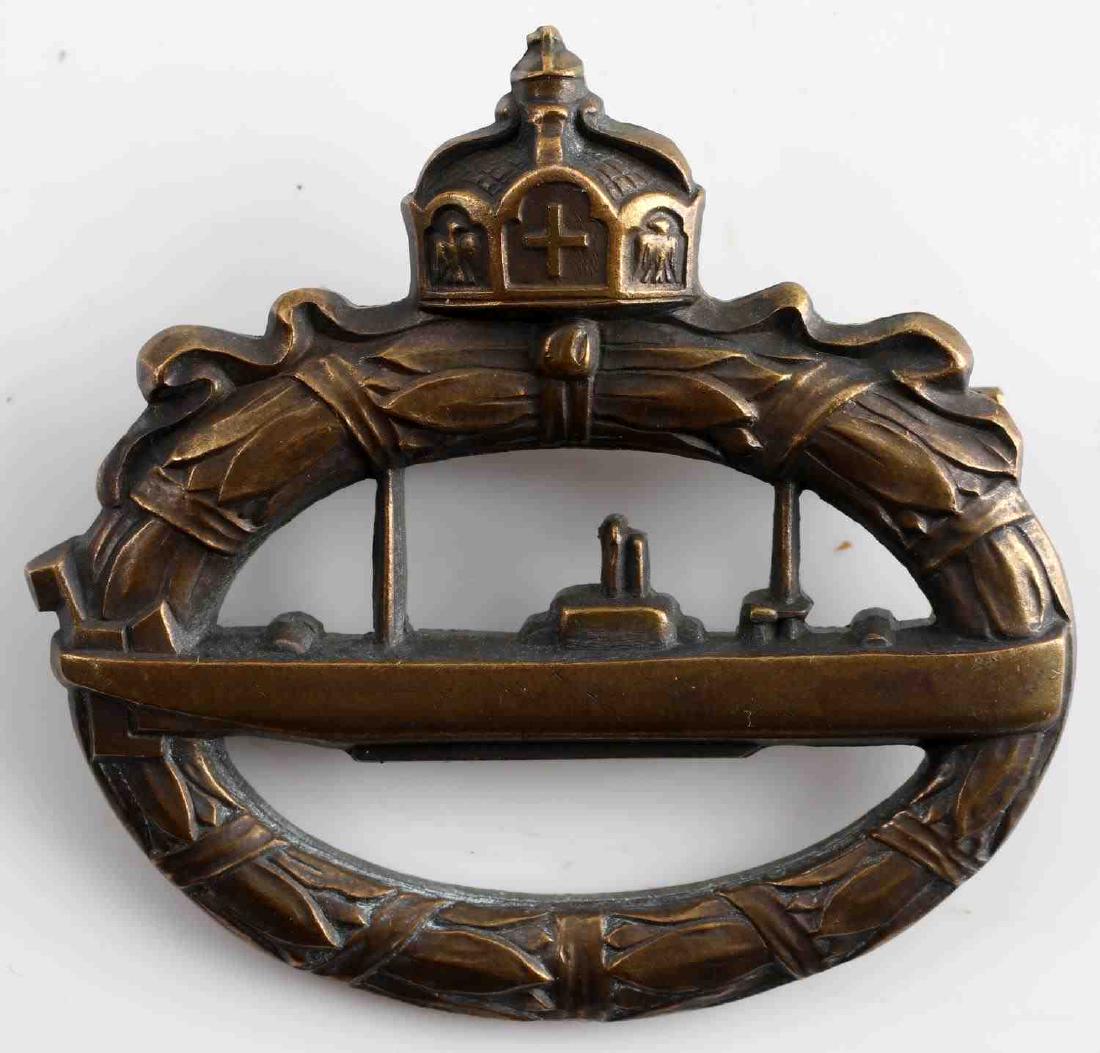 WWI IMPERIAL GERMAN BRASS U BOAT BADGE: German WWI U-boat badge. Cannon brass construction with top horizontal pin. Walter Schott fec. maker marked at bottom reverse. Some patina and very slight detail loss present. Excellent overall. This
