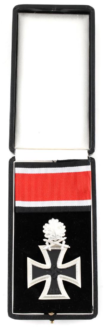 WWII THIRD REICH GERMAN IRON CROSS MEDAL W BOX: Iron cross with oak leaf and crossed swords piece above, marked 800 L/12 but is not testing as silver. Comes in case with ribbon. Good condition. Reproduction.