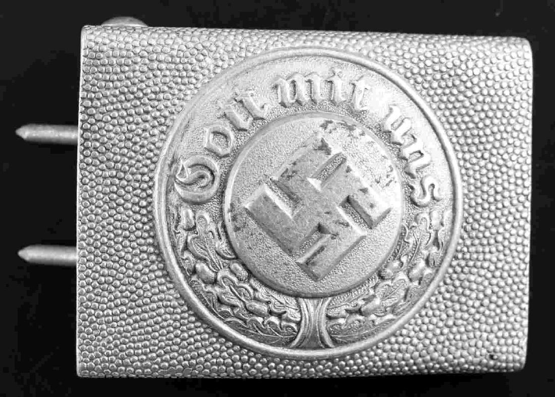 WWII GERMAN THIRD REICH POLICE EM BELT BUCKLE: German Police EM belt buckle. Aluminum construction with pebbled pattern. Reverse marked "OWP" within triangle. Very good overall. Some slight abrasions and patina present. This lot has a reserve.