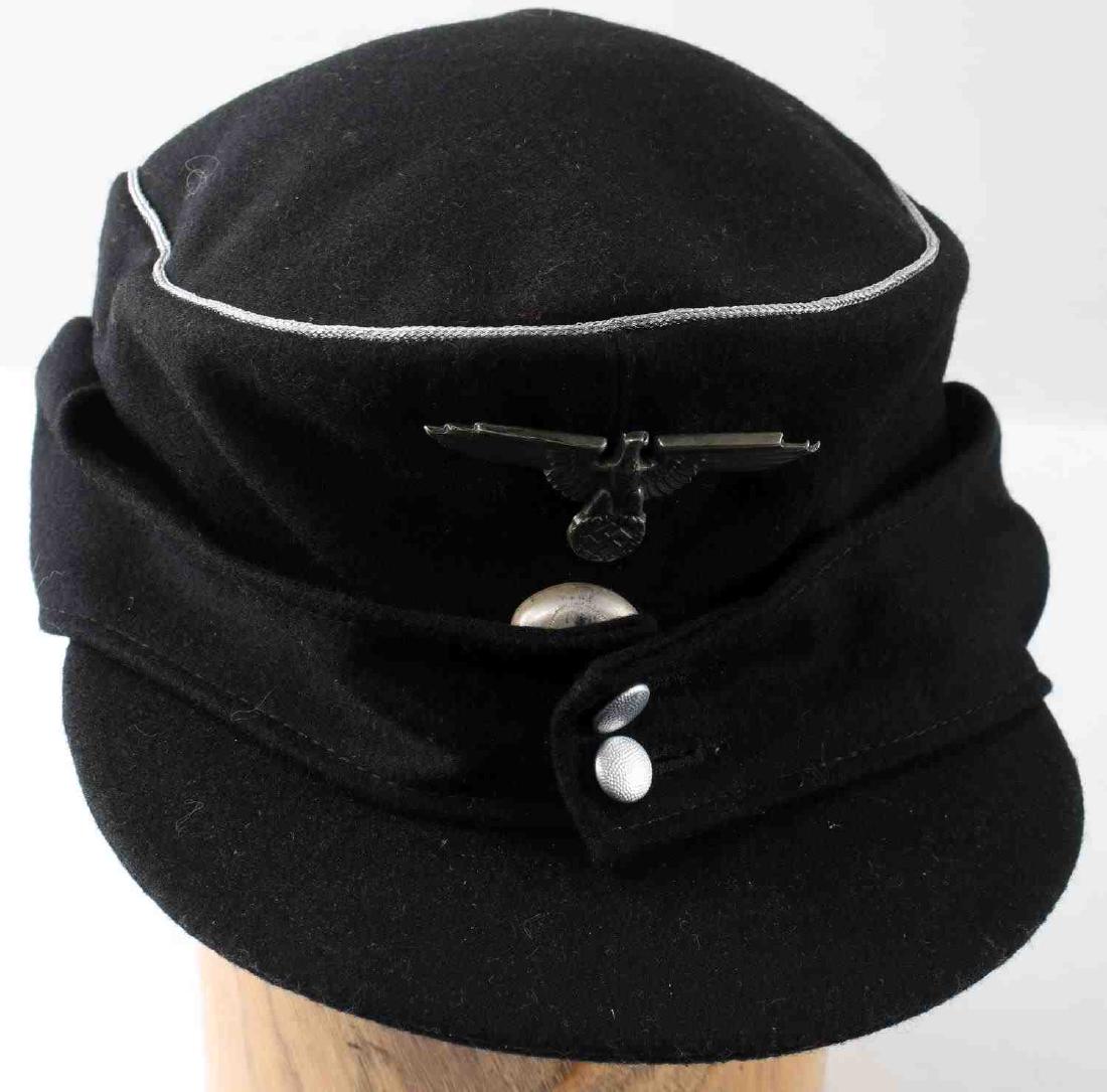 WWII GERMAN THIRD REICH SS M 43 FIELD CAP: German SS M-43 field cap. Black wool construction with Reichsadler and totenkopf cap badges and silver bullion wire piping. Both badges are RZM reverse marked. Interior of cap is ink marked, however m