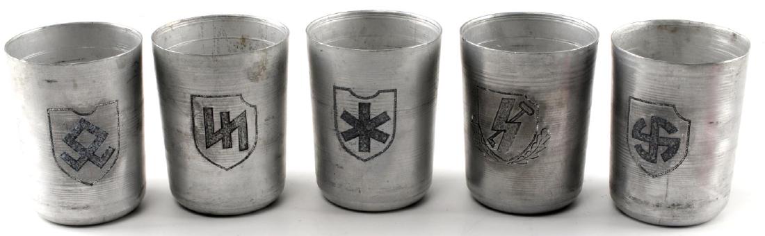 WWII GERMAN 3RD REICH SS DIVISION SCHNAPPS CUP LOT: Lot contains five Waffen SS Division schnapps cups. Includes "Des Reich", "Wiking", "Nord", "Prinz Eugen", "Hitlerjugand". Unauthenticated/Sold 'as is' This lot has a reserve.