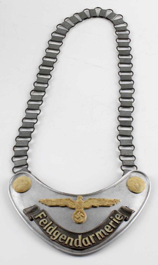 WWII GERMAN MILITARY POLICE FELDARMERIE GORGET: German miltary police Feldarmie gorget. Aluminum construction with felt backing. RZM marked "M34/2" on uniform hook. Good condition overall. Some staining, loss of detail, and signs of abrasions prese