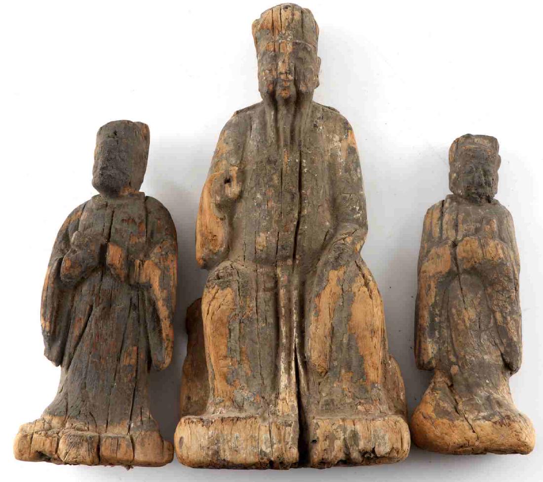 THREE CHINESE MING DYNASTY WOODEN FIGURES: Three carved statues. One standing figure measures 6.5 inches. One standing figure measures 7 inches. One seated figure measures 9.5 inches. Has possible traces of blue paint. All three are in damaged