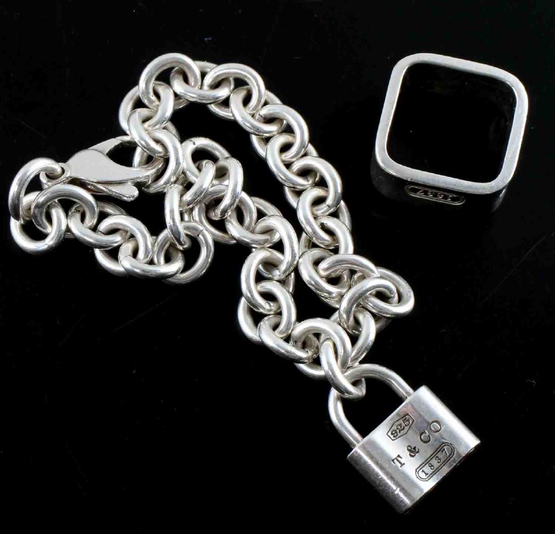 TIFFANY & CO SILVER RING AND LINK BRACELET 40 GRAM: Lot of TWO (2) includes: one (1) unisex square cushion silver ring (approx. size 5) and one (1) women's oval link bracelet with locket. All sterling silver. Both "925" & "Tiffany & Co" maker marked. T