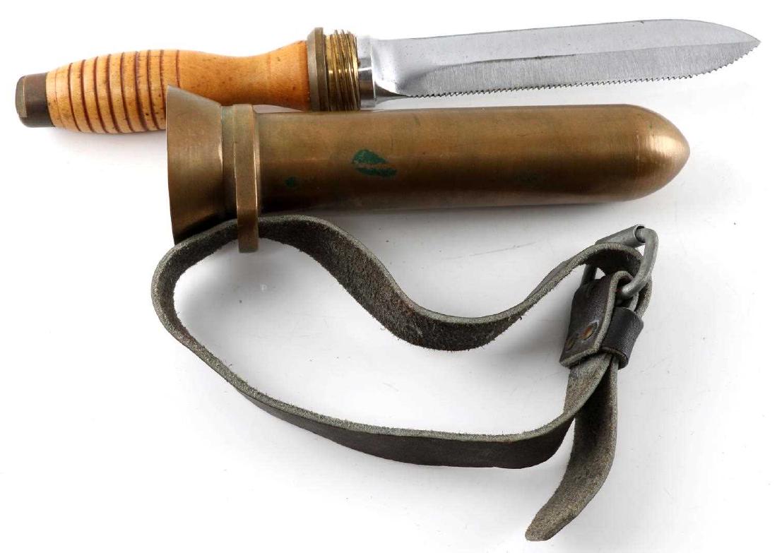 WWII US AMERICAN NAVY DESCO MARK V DIVING KNIFE: Mark V diving knife by Desco. Engraved "Desco" on brass scabbard. Maple handle with serrated saw back blade. 13.5" in total. Includes original heavy-duty leather strap.