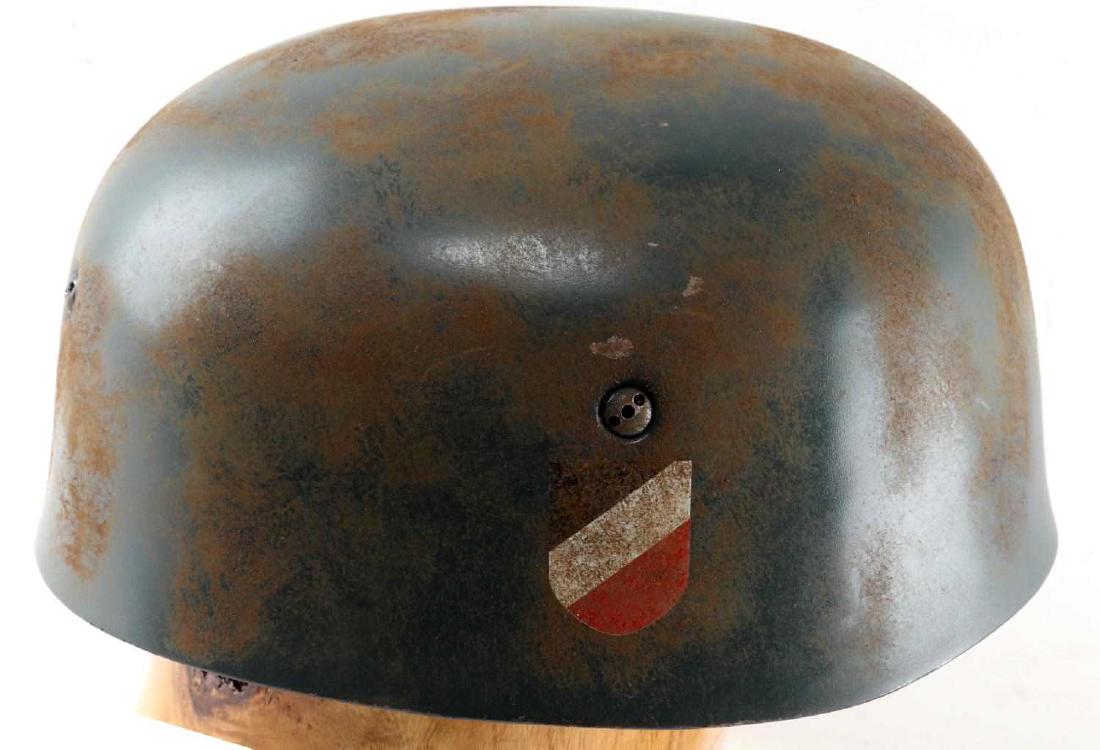 WWII GERMAN LUFTWAFFE PARATROOPER HELMET: German Luftwaffe Paratrooper helmet. Double decal version with tri-color national shield at one side and Luftwaffe Reichsadler at other. Leather interior marked "Kopfwelte Gr. 60 Stahlhaube Nr. 68". G