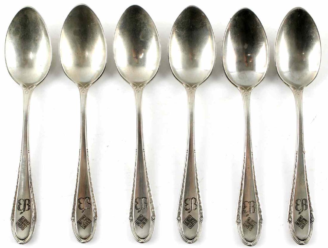 6 WWII GERMAN EVA BRAUN SILVER TEASPOON LOT: This lot includes a set of 6 tea spoons from the personal collection of Eva Braun. Spoons are Wellner made and bear the "EB" butterfly monogram of Eva Braun as well as the NSDAP swastika. Non-silver,