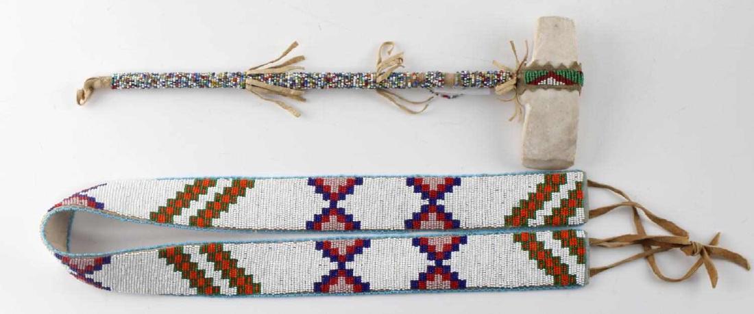 NATIVE AMERICAN BEADED STONE TOMAHAWK AND BELT: Modern Native American items: 36 inch belt with cloth to one side, and a tomahawk with stone axe and beaded shaft. Some loss of beading to tomahawk. Good condition.
