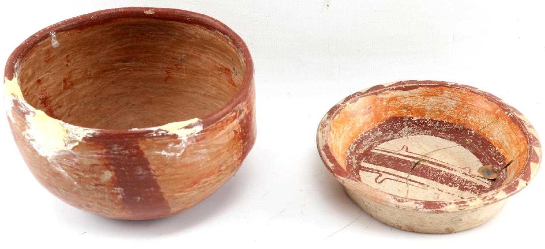 TWO CENTRAL AMERICAN POLYCHROME BOWLS: One small shallow bowl. Orange and red hues with geometric design. Cracked in multiple places and repaired. Measures 5.25 inches by 1.25 inches. One larger bowl with tan and red striped decoration. Me