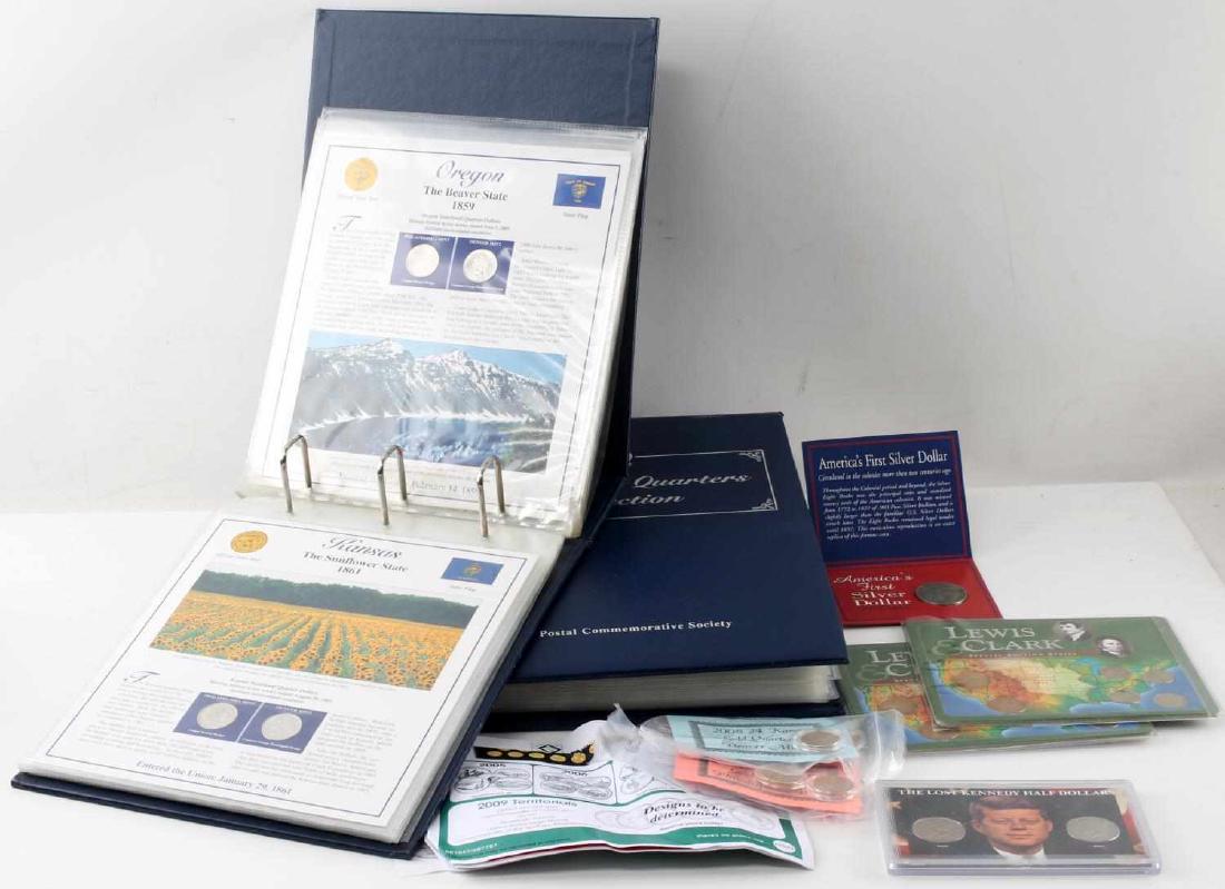 LARGE COLLECTORS LOT STATEHOOD QUARTERS & MORE: Large Numismatics collectibles lot including but not limited to : two blue statehood quarters albums with 2 quarters per page, America's first silver dollar (1793 replica) , the lost Kennedy half doll