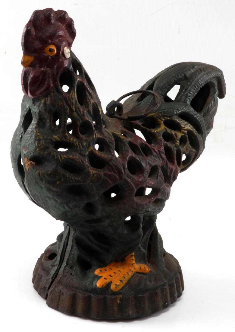 CAST IRON VINTAGE ROOSTER CANDLE LANTERN LAMP: Cast iron is painted. Can hang by an O ring attached to top. Measures 9.25 inches by 7 inches by 5 inches. In very good condition.